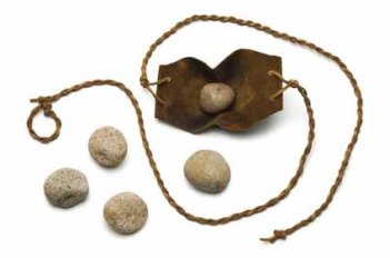 Sling and five smooth stones used by David to kill Goliath on a white background